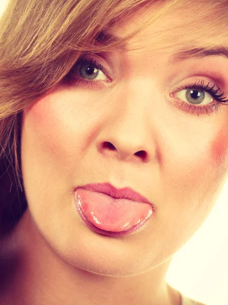 Closeup portrait of woman sticking tongue out — Stock Photo, Image