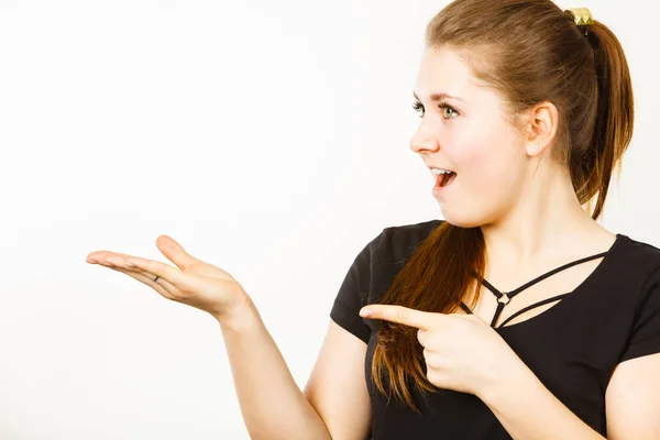 Happy positive woman pointing at something — Stock Photo, Image