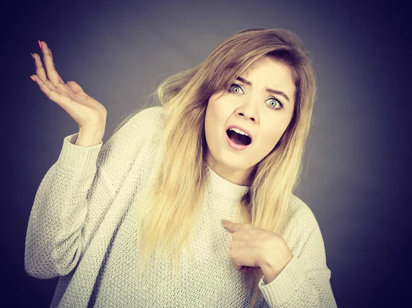Confused young blonde woman gesturing with hands — Stock Photo, Image