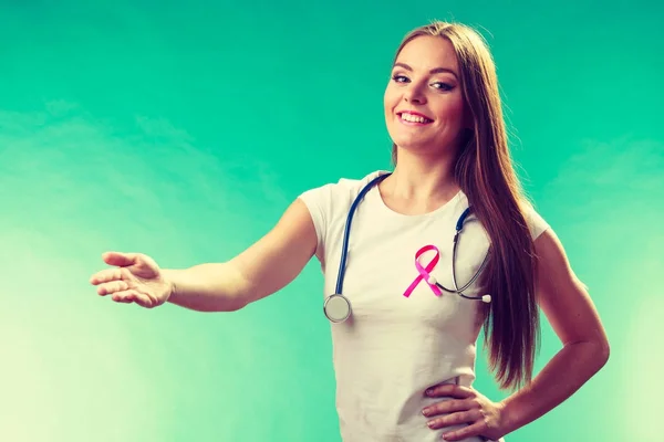 Woman pink ribbon on chest making welcome gesture — Stock Photo, Image