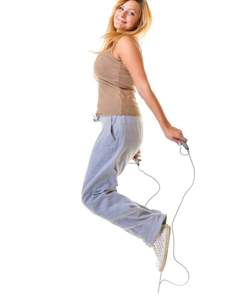 Happy blonde woman jumping on skipping rope — Stock Photo, Image