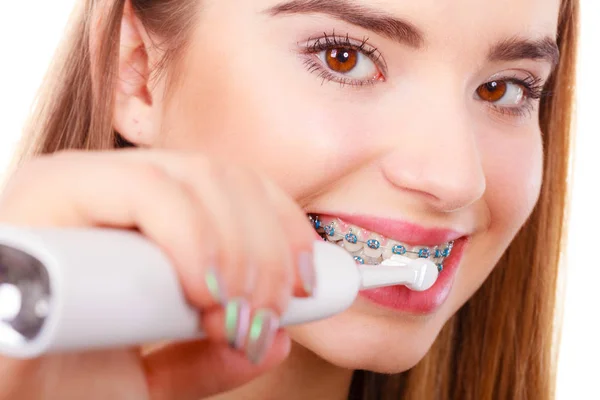 Жінка посміхається чистити зуби за допомогою дужок — стокове фото