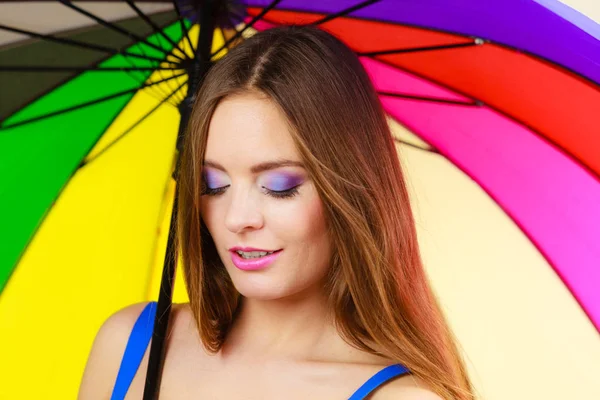 Woman standing under colorful rainbow umbrella — Stock Photo, Image
