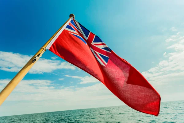 Uk red ensign the british maritime flag flown from yacht — Stock Photo, Image