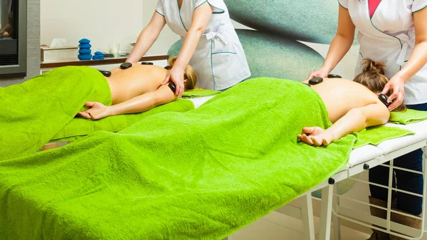 Massage with hot rocks stones in beautician — Stock Photo, Image