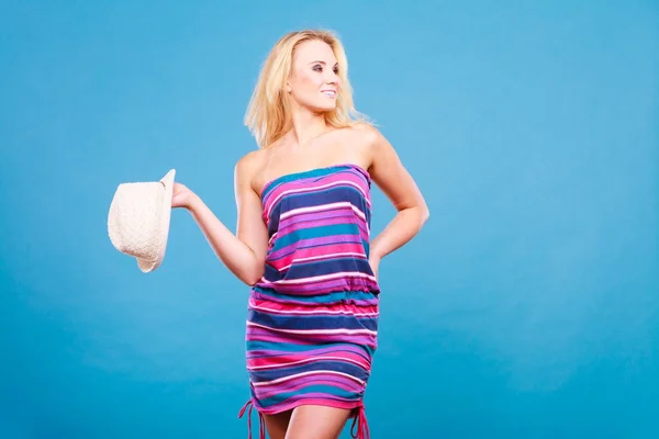 Blonde woman wearing short colorful striped dress — Stock Photo, Image