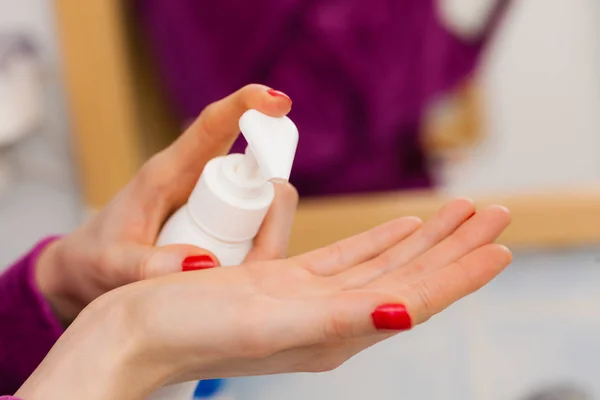 Woman applying hand cream on hands — Stock Photo, Image