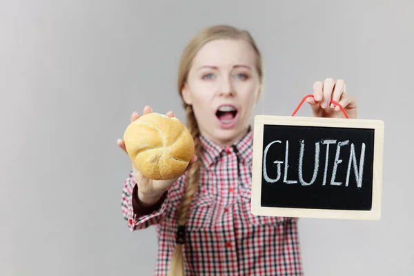 Mulher segurando placa com sinal de glúten e pão de pão — Fotografia de Stock