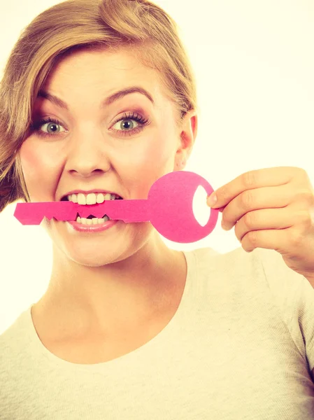 Teenage girl with braid biting key — Stock Photo, Image