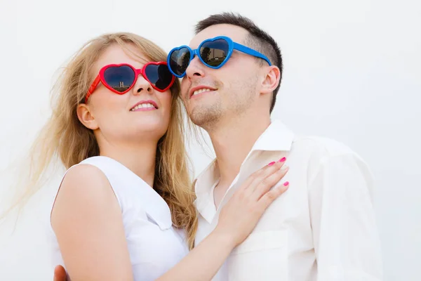 Man and woman wearing heart shape sunglasses — Stock Photo, Image