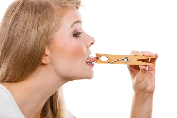 Blonde woman having tongue in clothespin — Stock Photo, Image