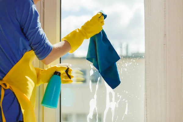 Hand cleaning window at home using detergent rag — Stock Photo, Image