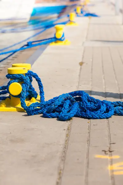 Sailing ropes tied around pins in sunlight — Stock Photo, Image