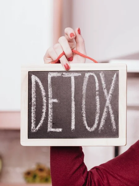 Happy woman holding board with detox sign — Stock Photo, Image