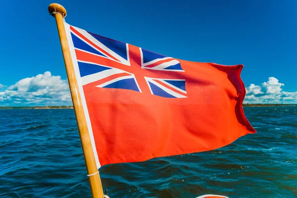 Uk red ensign the british maritime flag flown from yacht — Stock Photo, Image