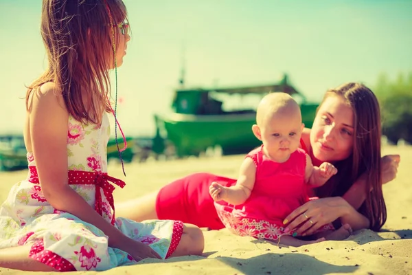 Woman spending time with kids on beach — Stock Photo, Image