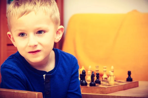 Young kid boy playing chess having fun — Stock Photo, Image