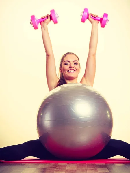 Mädchen wärmt sich mit Ball und Klingelgewichten auf. — Stockfoto