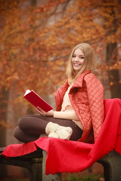 Woman sitting with book in park — Stock Photo, Image