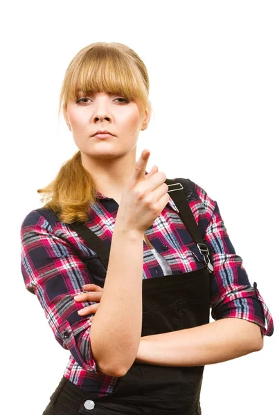 Angry woman wearing dungarees pointing — Stock Photo, Image