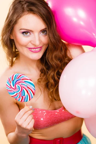 Woman holds lollipop candy and balloons — Stock Photo, Image