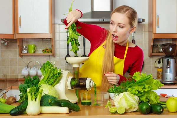 Mulher na cozinha fazendo suco de smoothie vegetal — Fotografia de Stock