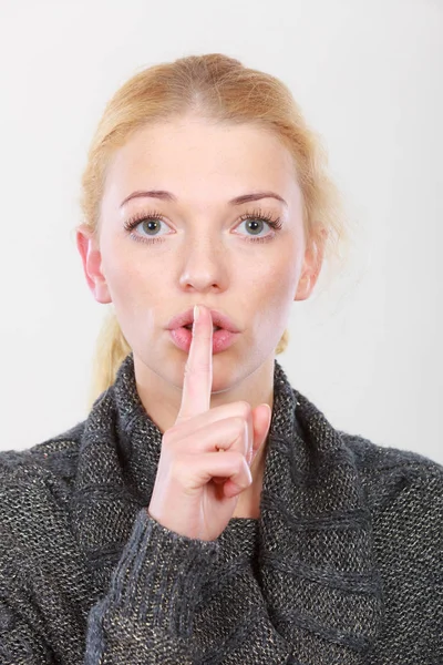 Woman holding finger close to lips, silence — Stock Photo, Image