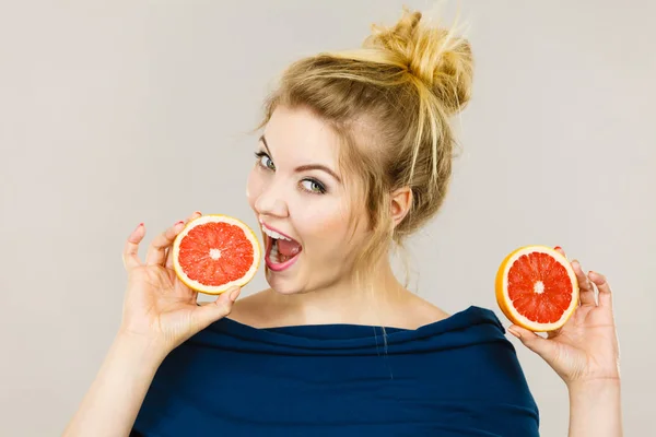 Feliz mujer sonriente sosteniendo pomelo rojo — Foto de Stock