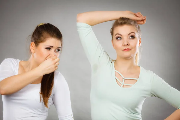 Woman having wet armpit her friend smelling stink — Stock Photo, Image