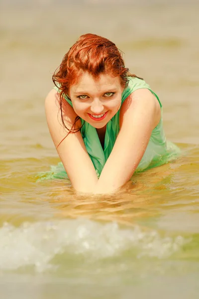 Redhead woman posing in water during summertime — Stock Photo, Image