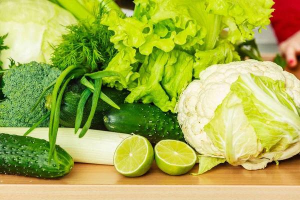 许多绿色蔬菜在厨房的桌子上 — 图库照片