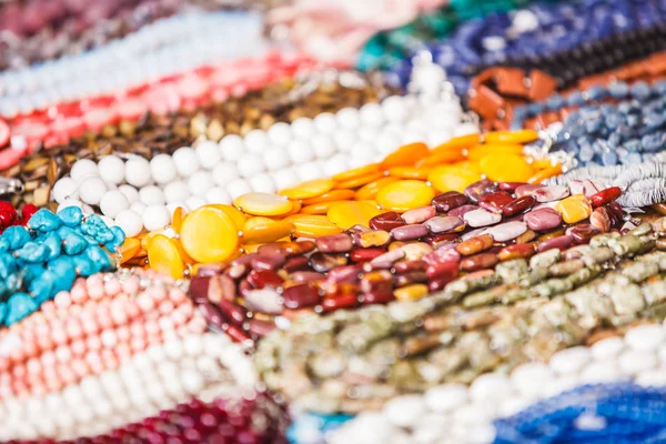 Many decorative necklaces made of colorful stones — Stock Photo, Image