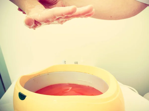 Woman getting paraffin hand treatment at beautician — Stock Photo, Image