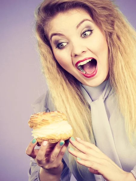 Funny woman holds cream puff cake — Stock Photo, Image