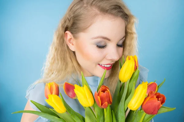 Pretty woman s bandou červené žluté tulipány — Stock fotografie