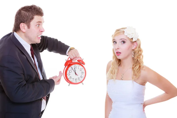 Groom holding big red clock yelling and bride — Stock Photo, Image