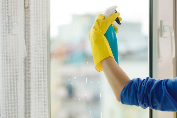 Hand cleaning window at home using detergent rag — Stock Photo, Image
