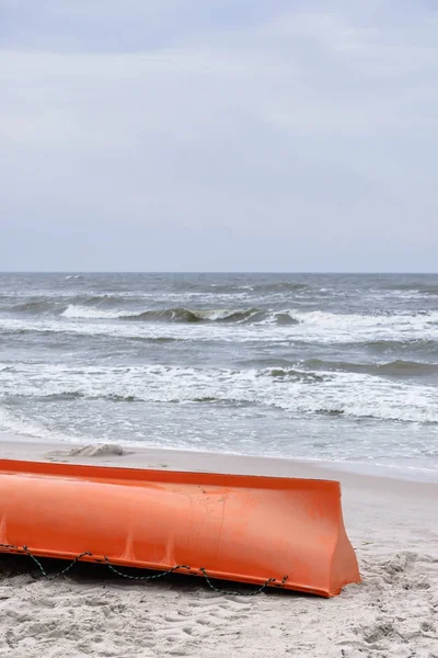 Orange boat on sandy beach — Stock Photo, Image