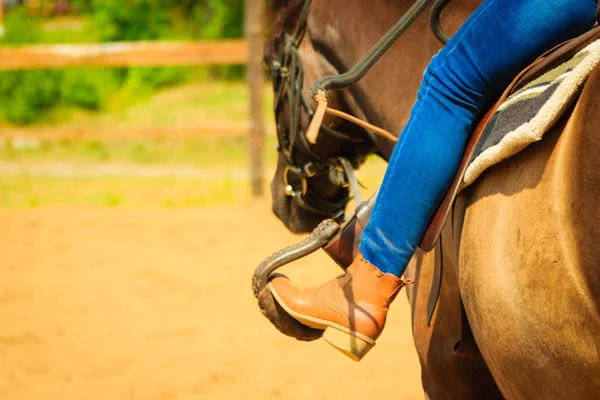 Woman foot in stirrup on horse saddle — Stock Photo, Image