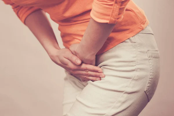 Woman with hands holding her crotch — Stock Image Woman with hands holding her crotch Royalty Free Stock Images