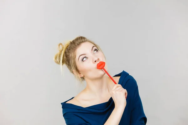 Funny woman holding big red lips on stick — Stock Photo, Image