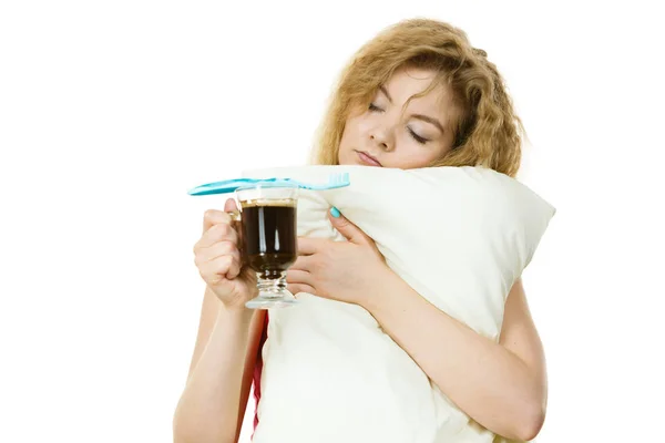 Tired woman holding toothbrush and coffee — Stock Photo, Image