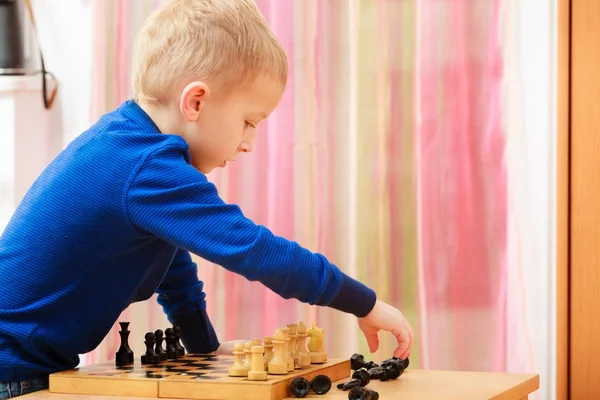 Young kid boy playing chess having fun — Stock Photo, Image