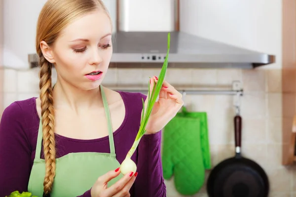 Vrouw in de keuken houdt groene verse bieslook — Stockfoto