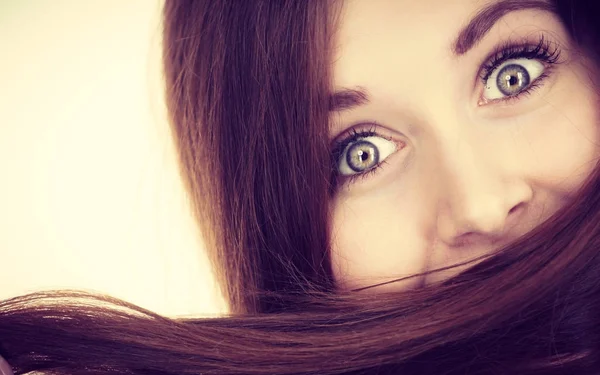 Woman having face covered with her brown hair — Stock Photo, Image