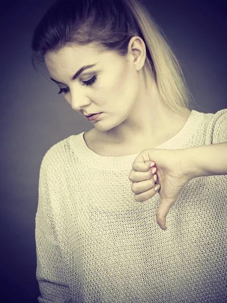 Sad woman showing thumb down gesture — Stock Photo, Image