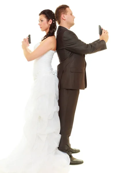 Groom and bride in wedding outfit holding guns — Stock Photo, Image