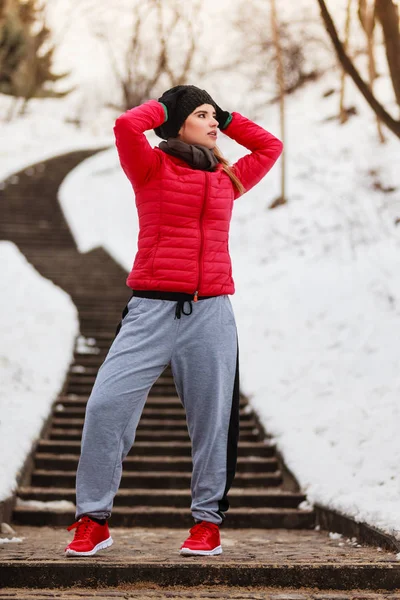 Mujer con ropa deportiva ejercitándose al aire libre durante el invierno — Foto de Stock