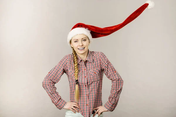 stock image Positive girl wearing blowing santa claus hat