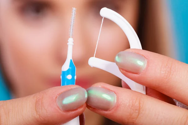 Woman holding small toothbrush and dental floss — Stock Photo, Image